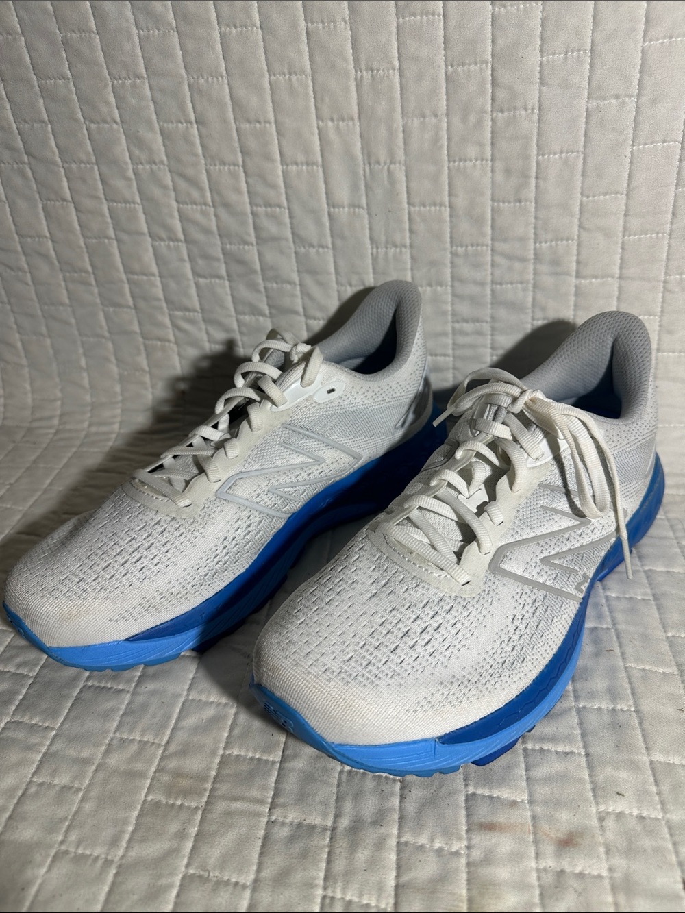 New Balance Fresh Foam X 880v12 running shoes in white and blue.